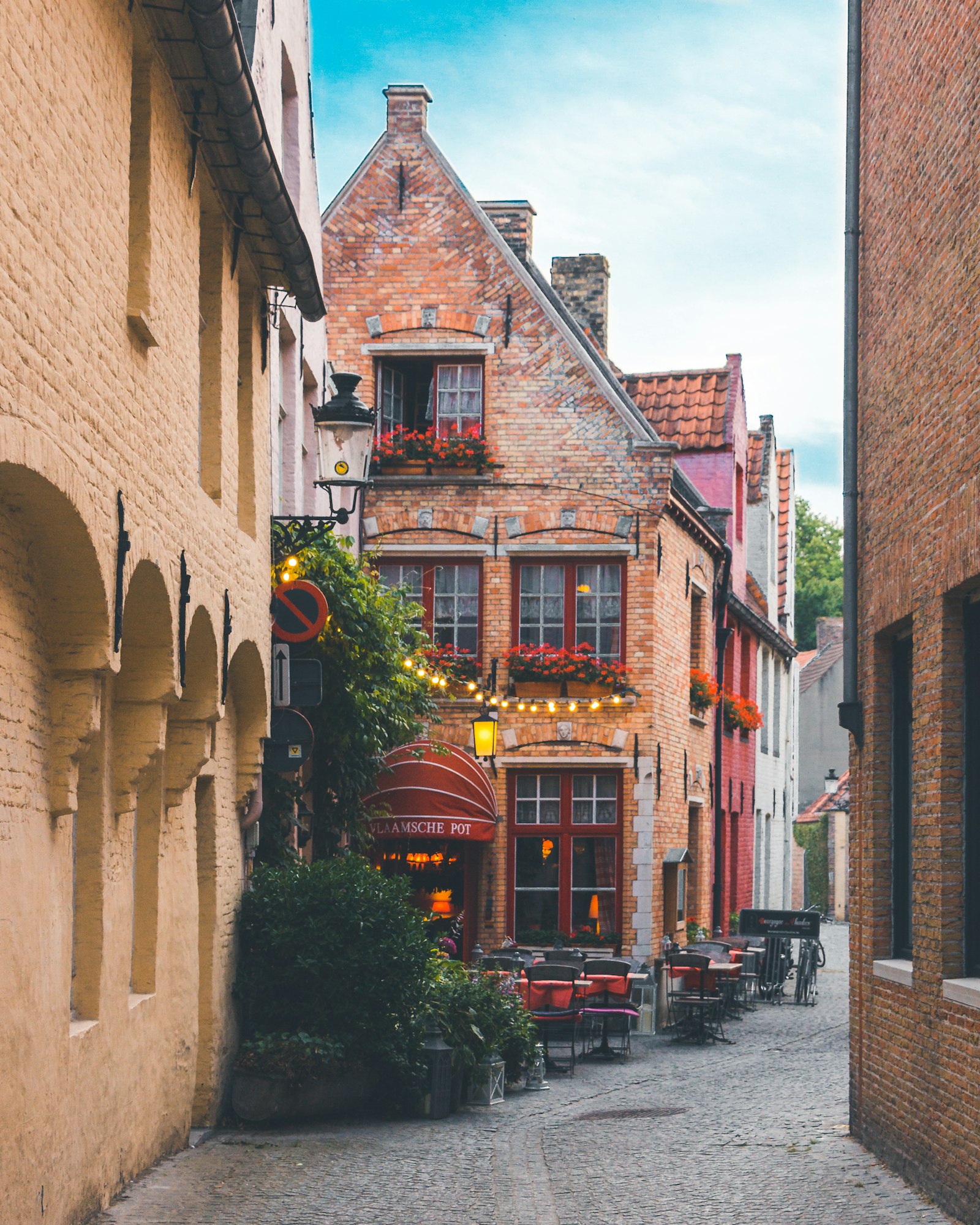 Cobblestone street lined with brick buildings in Bruges