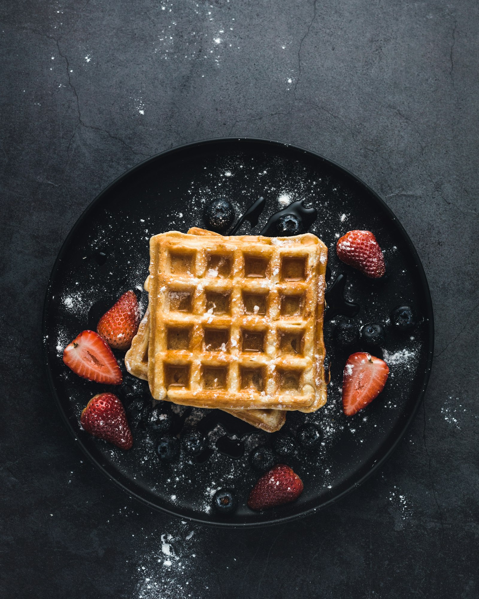 Square Belgian waffle with strawberries, a treat kids love in Brussels