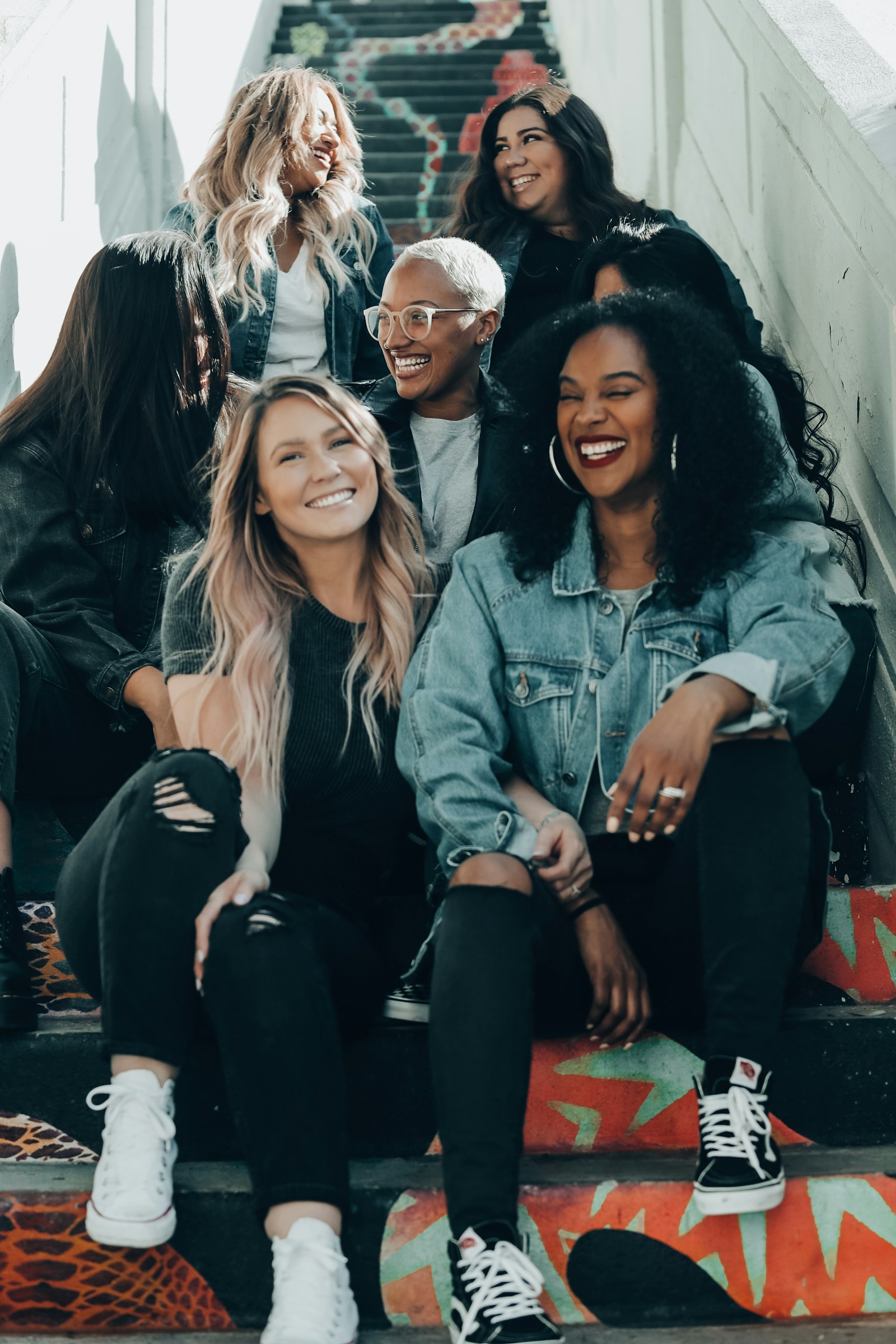 Group of women laughing together on stairs